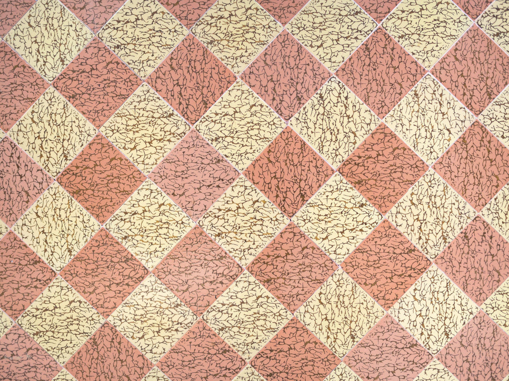 Harlequin Tile wallpaper in dusky pink and cream diamonds