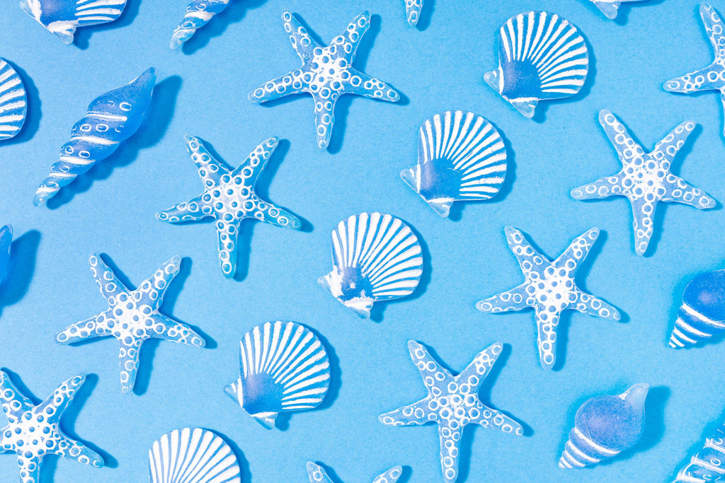 Ocean Treasures, peel and stick wallpaper, playful starfish and seashell motifs scatter across a bright ocean background