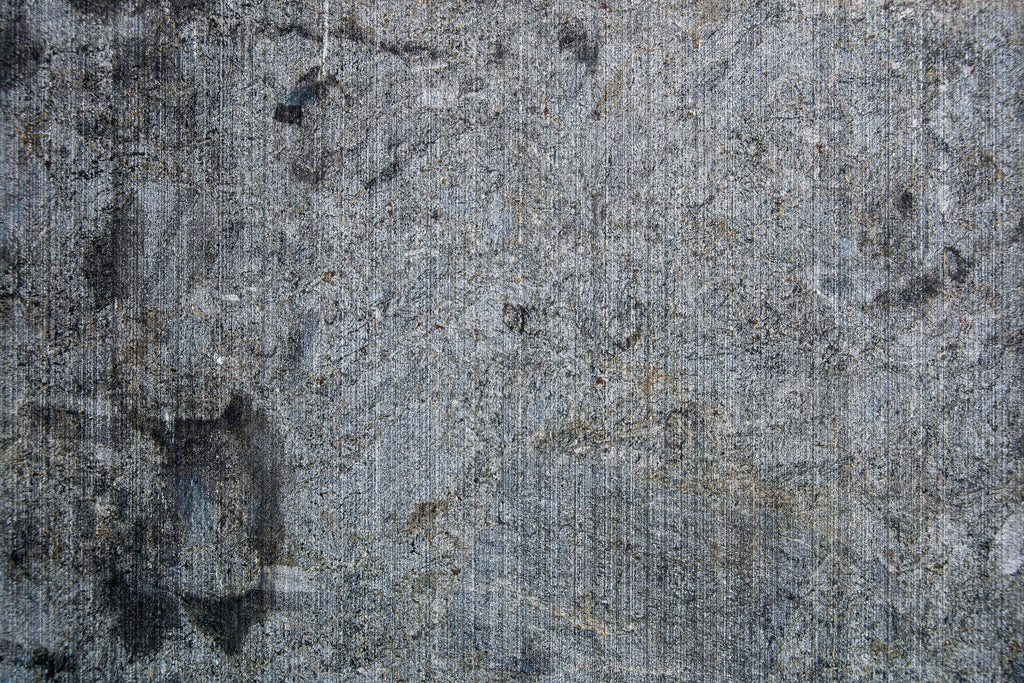 Raw Concrete, peel and stick wallpaper, distressed concrete textures and layered gray tones create an industrial-inspired