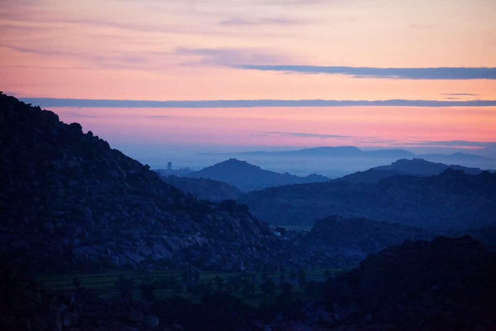 Twilight Ridges, wallpaper mural, layers of rocky hills fade into a tranquil dusk sky, painted with soft pinks and cool