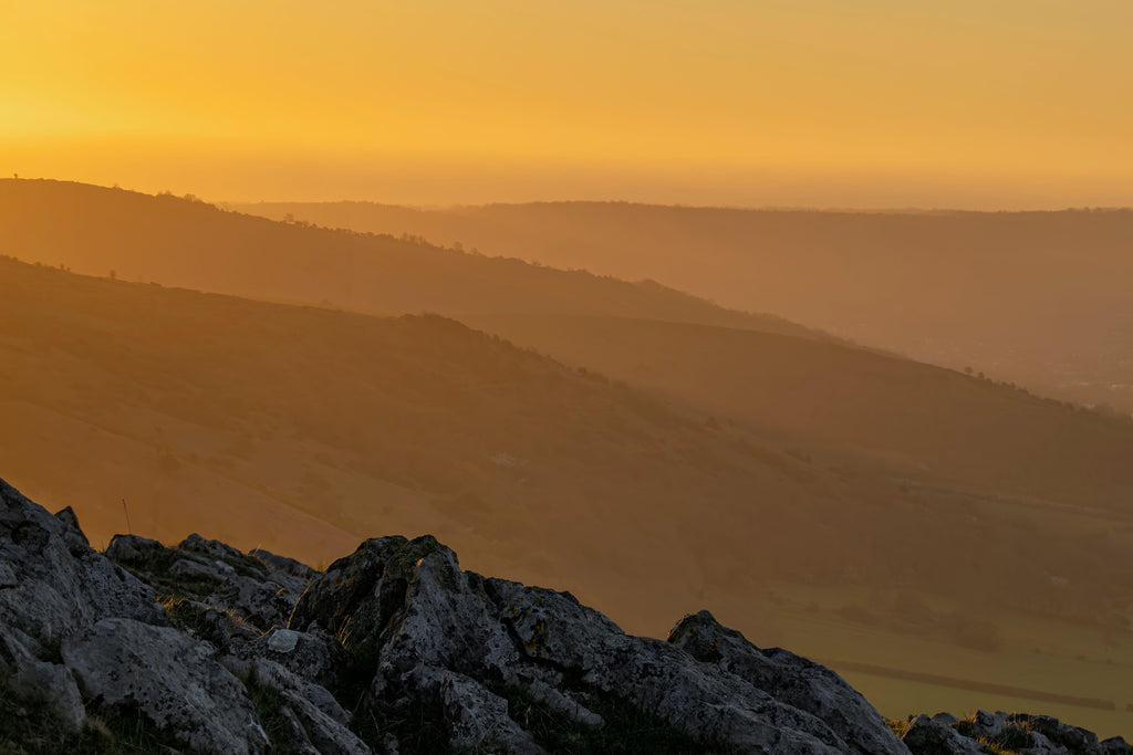 Amber Vista, wallpaper mural, golden light washes over distant hills, creating a serene landscape filled with warmth
