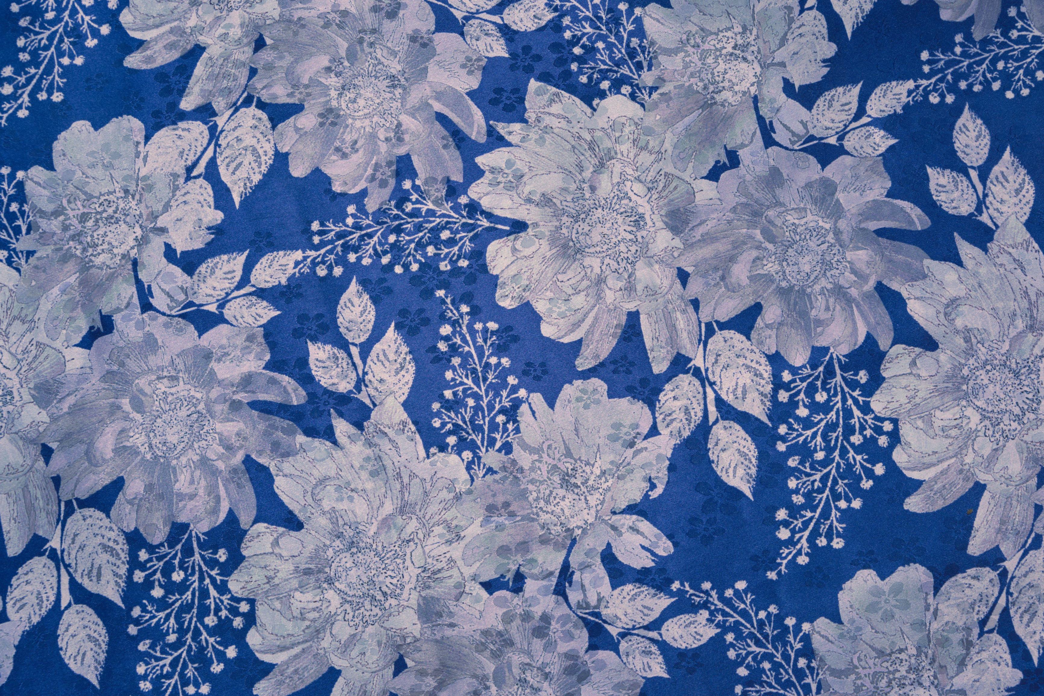 Cobalt Bloom wallpaper with pale blooms on cobalt blue