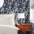 Eucalyptus Love in Navy by De-Anne Strange, peel and stick wallpaper styled in a bedroom